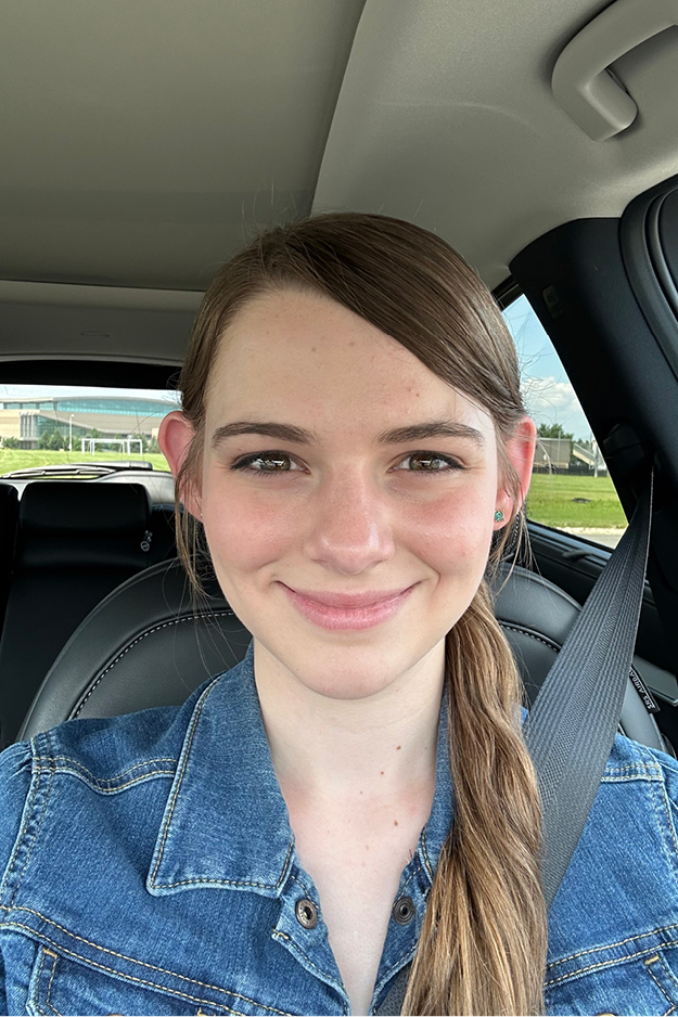 Female student sitting in car