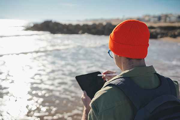 Researcher taking notes at waters edge