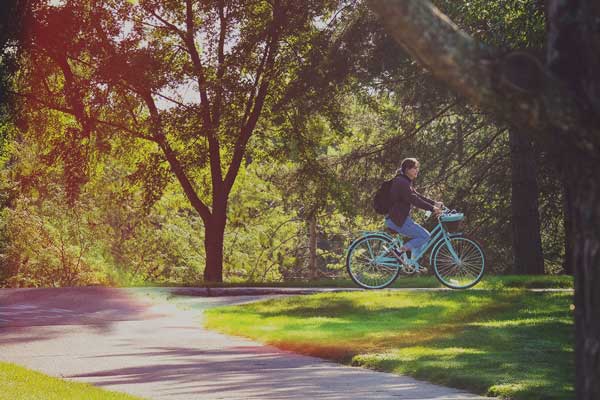 Student riding bike on UW-Green Bay campus