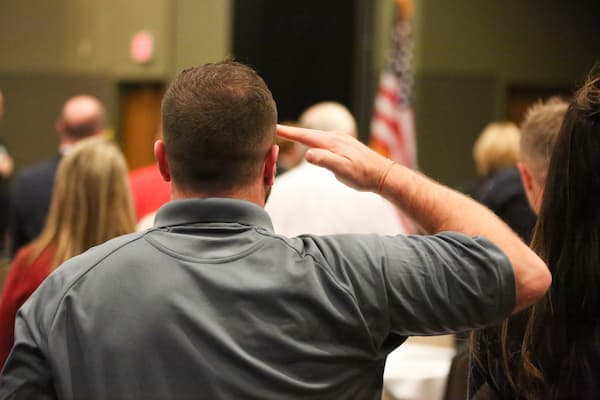 Attendee soluting at the Chancellor's Veteran's Day Celebration