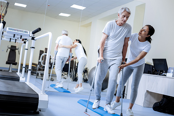 Physical therapist helping a senior patient