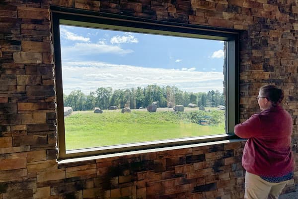 Woman looking out window to beautiful landscape