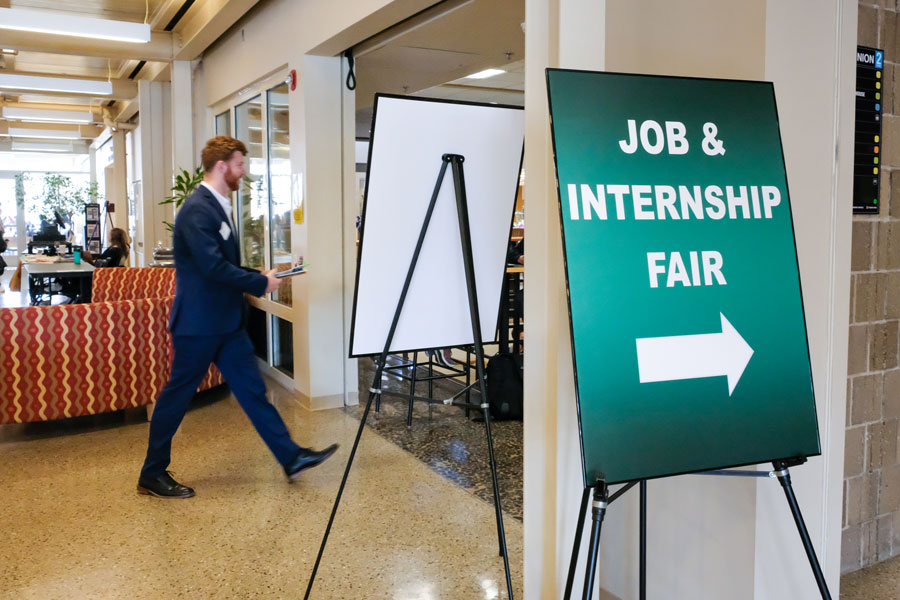 Student in suit walking into UW-Green Bay Job & Internship Fair