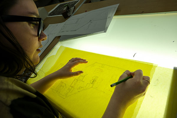 UWGB student uses a light table in Environmental Design studio class