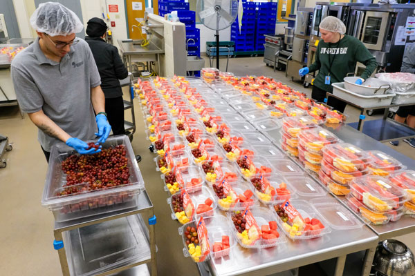 Graduate student prepping food during summer practicum