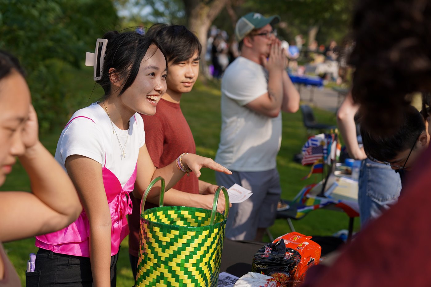 Students speak to event participants at a table