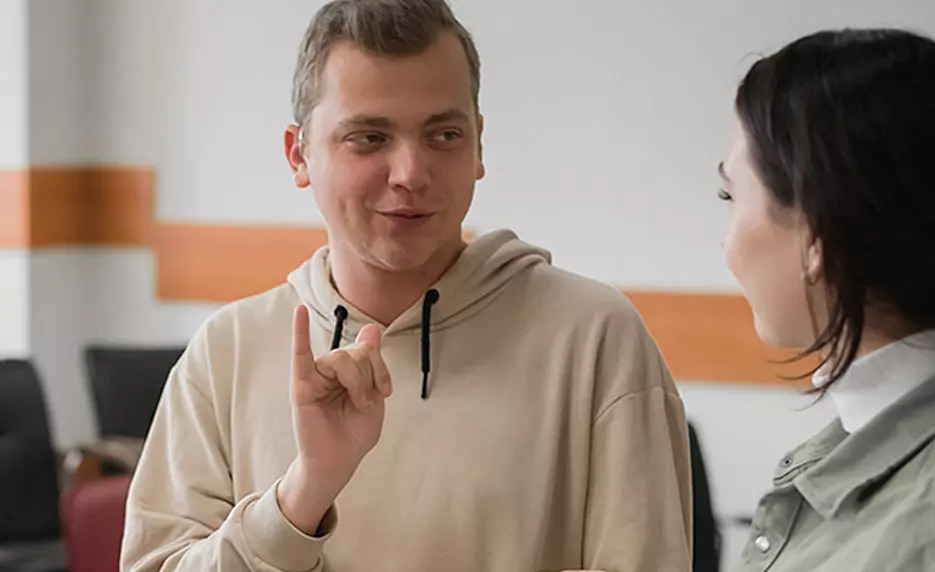 man using sign language to communicate