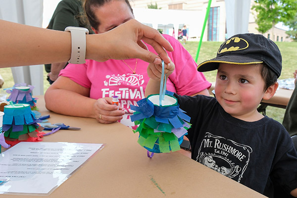 Young boy creating art at a festival