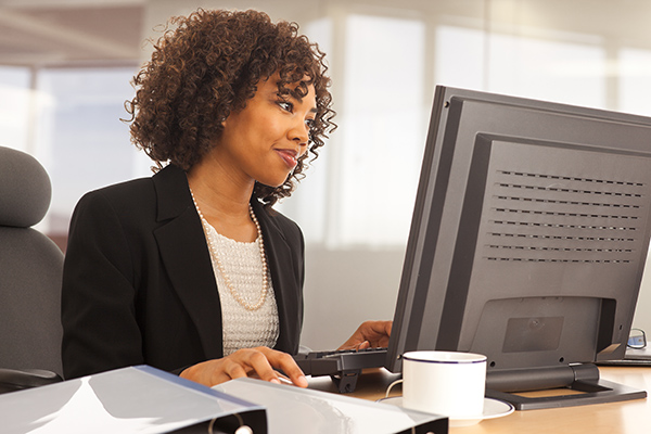 Young professional at desk with computer