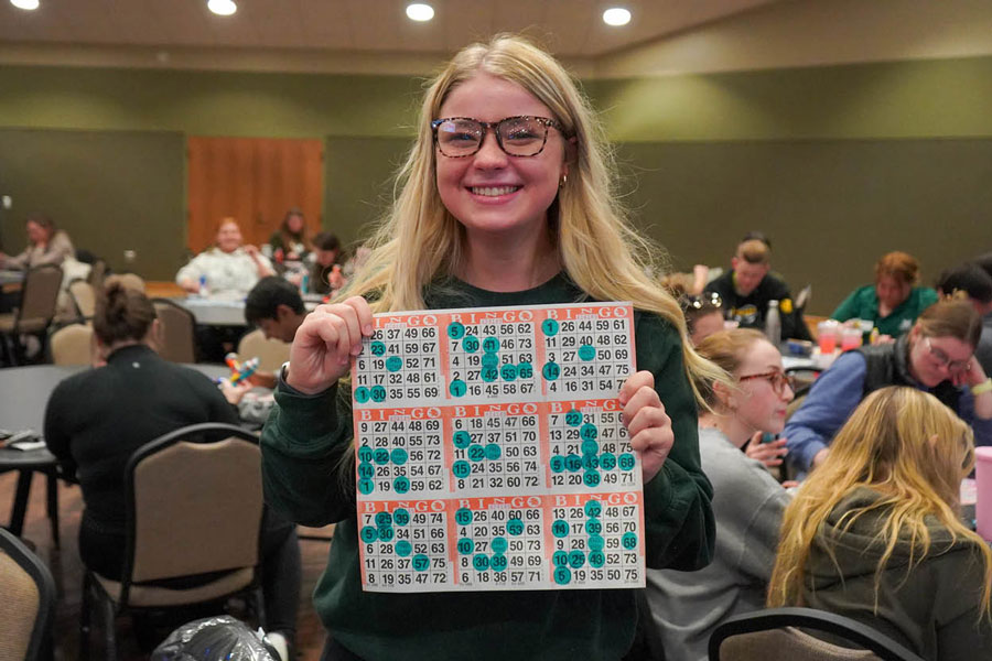 UW-Green Bay students holds up winning bingo card