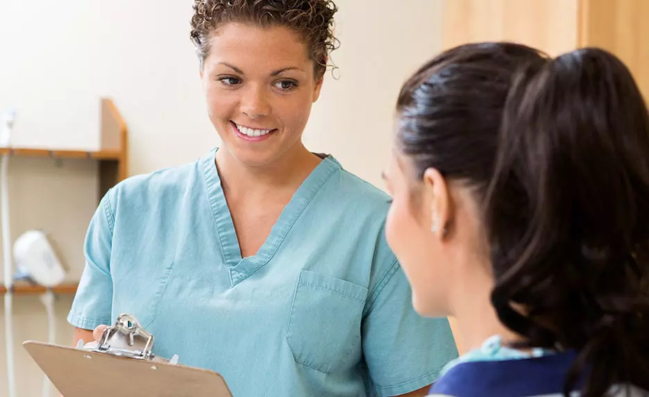 woman helping patient certified clinical medical assistant