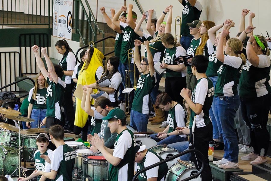 Pep band students cheering at a game