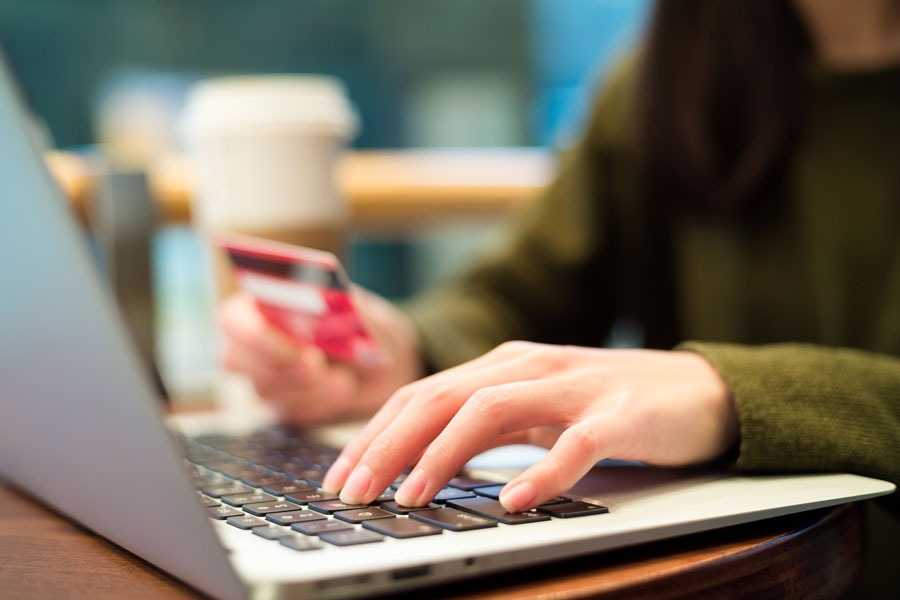 Person at lap top with credit card