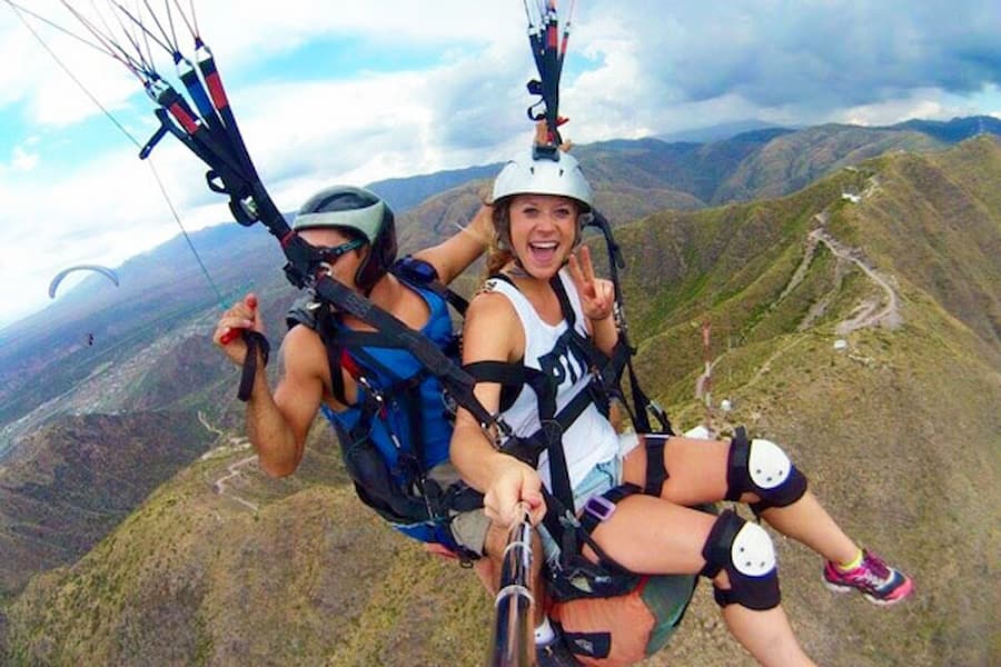 Two study abroad students paragliding