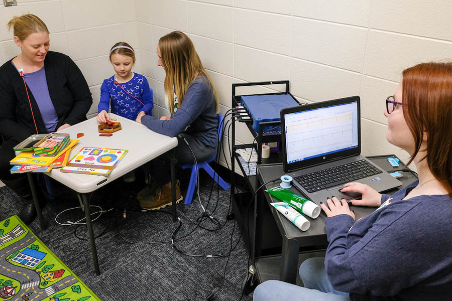 Researchers recording data while working with a child