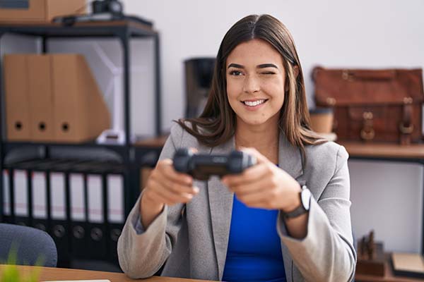 woman holding video game controller at work