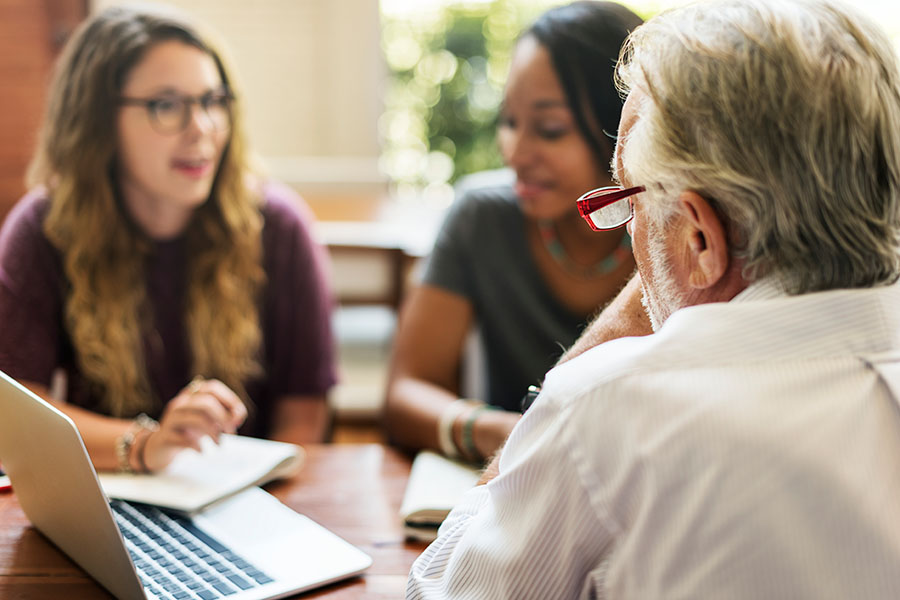 employees in discussion with supervisor