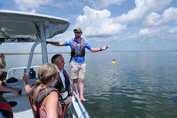 Man on boat giving tour of bay area