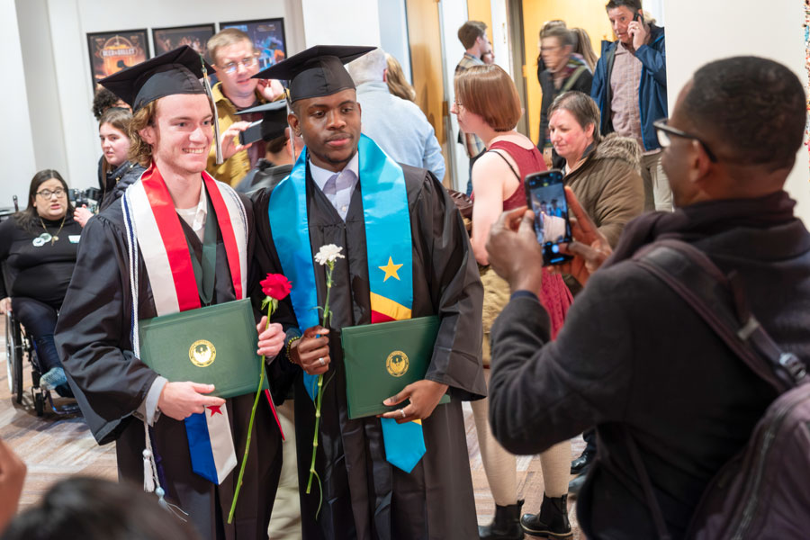 International students in cap and gown at commencement