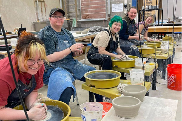 Students throwing pottery