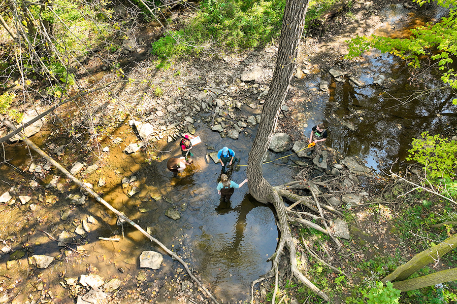 Drone shot of researchers in creek