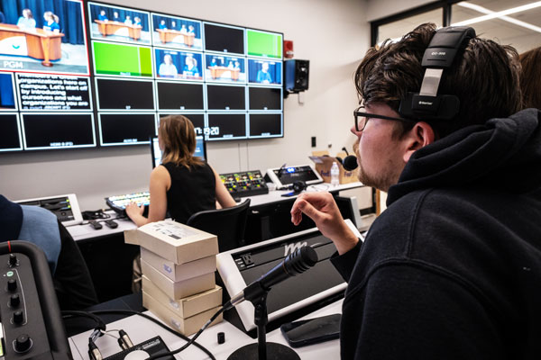 Students work on news broadcast in video production lab