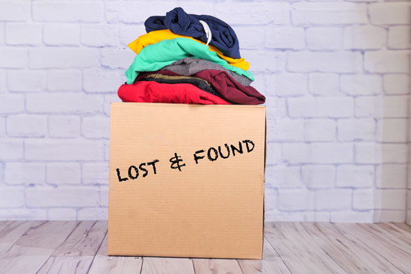 Cardboard lost and found box with clothes