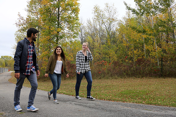 3 students walking on path