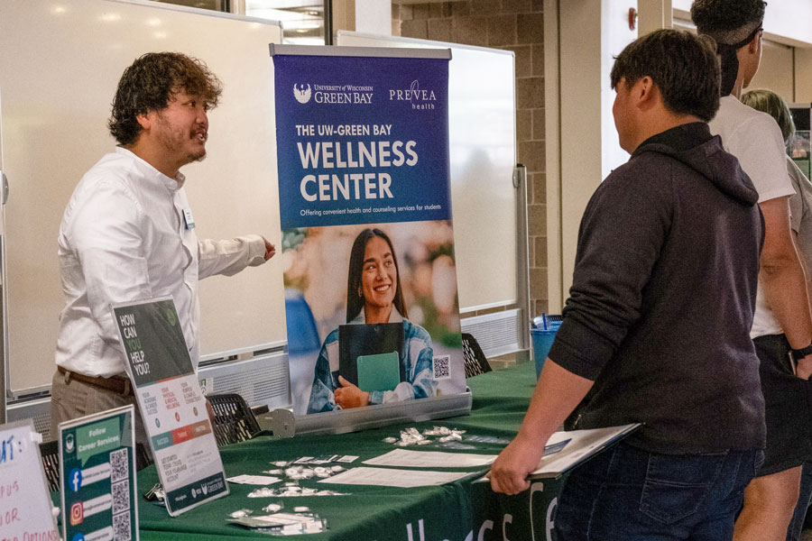 Student talking to Wellness Center staff