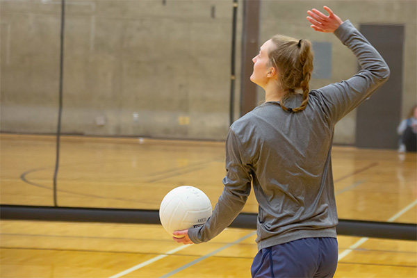 Student working on her volleyball serve