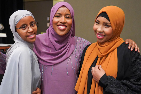 Three female students in hijabb at event