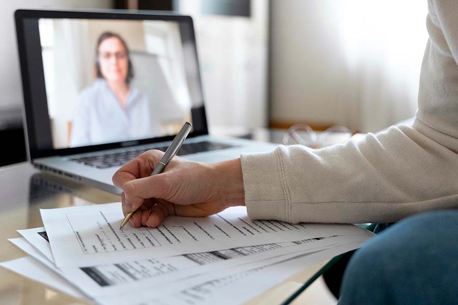 woman taking online training on laptop