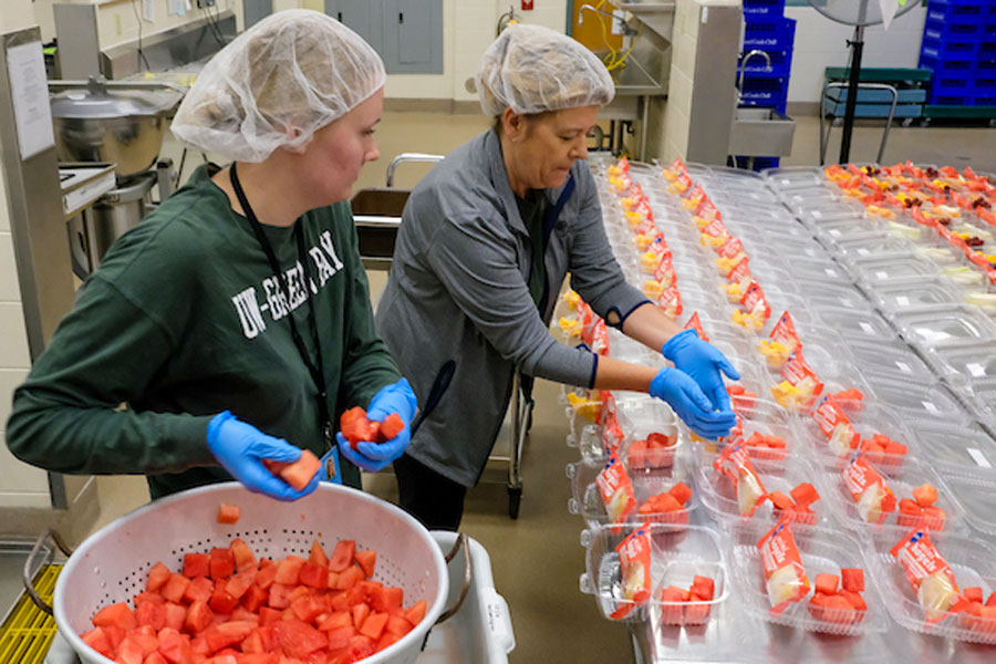 Graduate student working in kitchen at her summer practicum