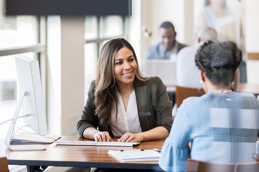 woman clerk sitting across from resident