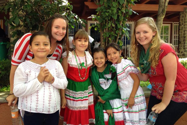 Study abroad students take photo with local children