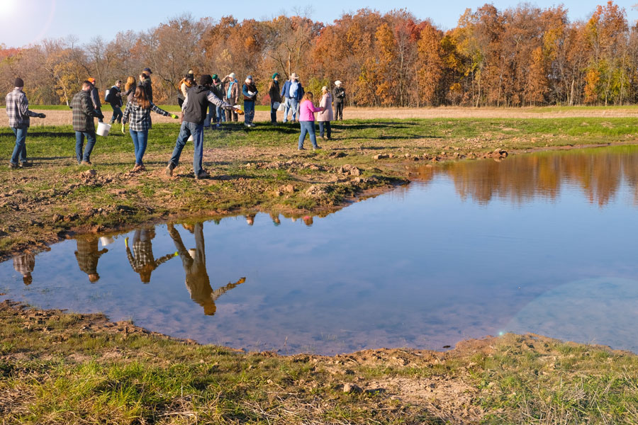 Students spread wet meadow plant seeds