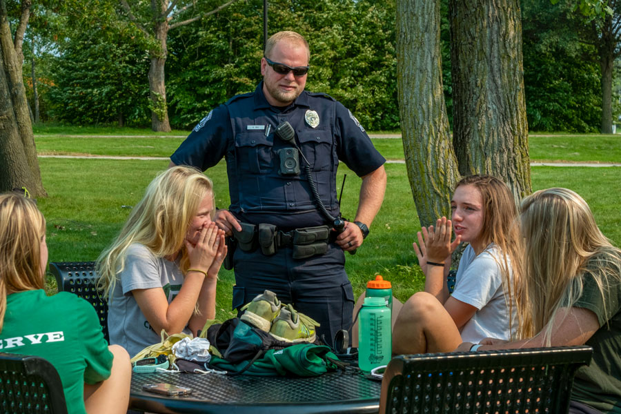 University Police officer talking with students outside