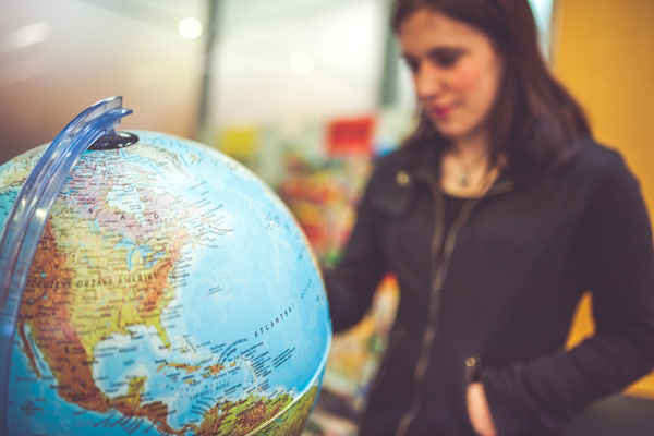 Female looking at globe