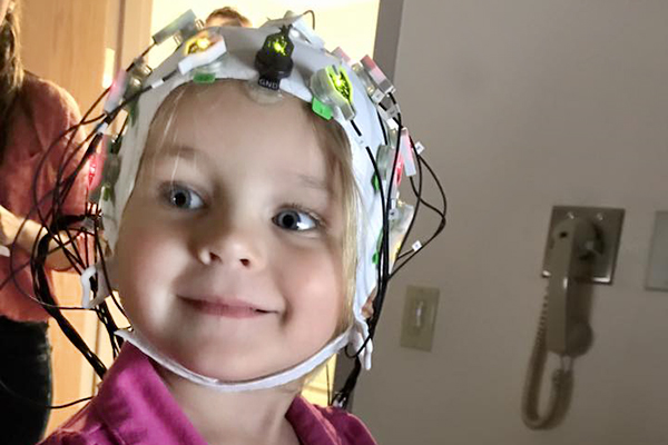 Young girl in an EEG cap