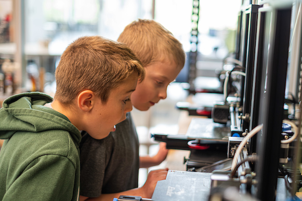 Two campers working on design tech