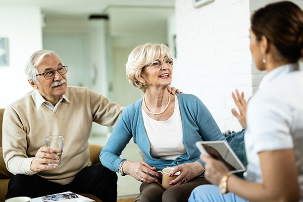 Young woman consulting older couple