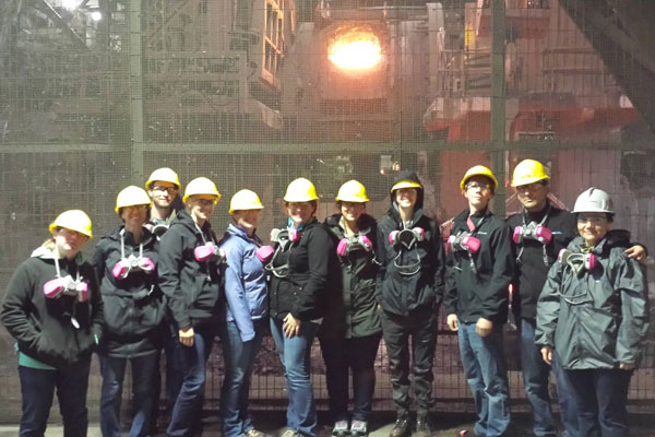 Students in hard hats touring mine