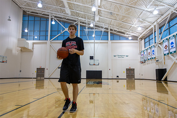 Student shooting hoops in the east gym