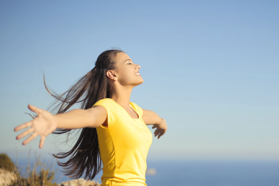 Female standing with outstretched arms