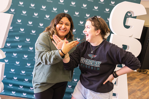 Two students wearing UW-Green Bay apparel