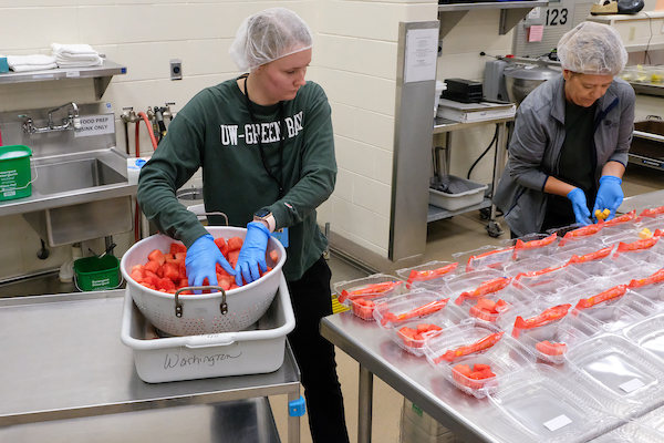 Dietetic student prepping food for Green Bay Public Schools during practicum