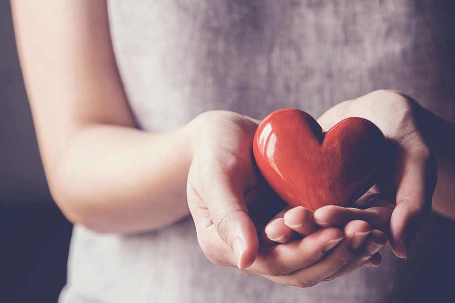 Hands holding red heart