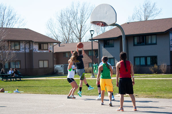Students playing outdoor intramural basketball