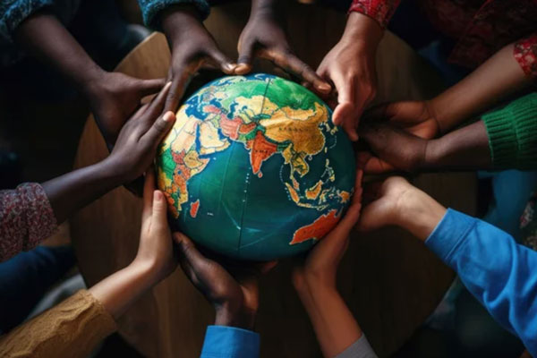 Diverse group of hands holding globe