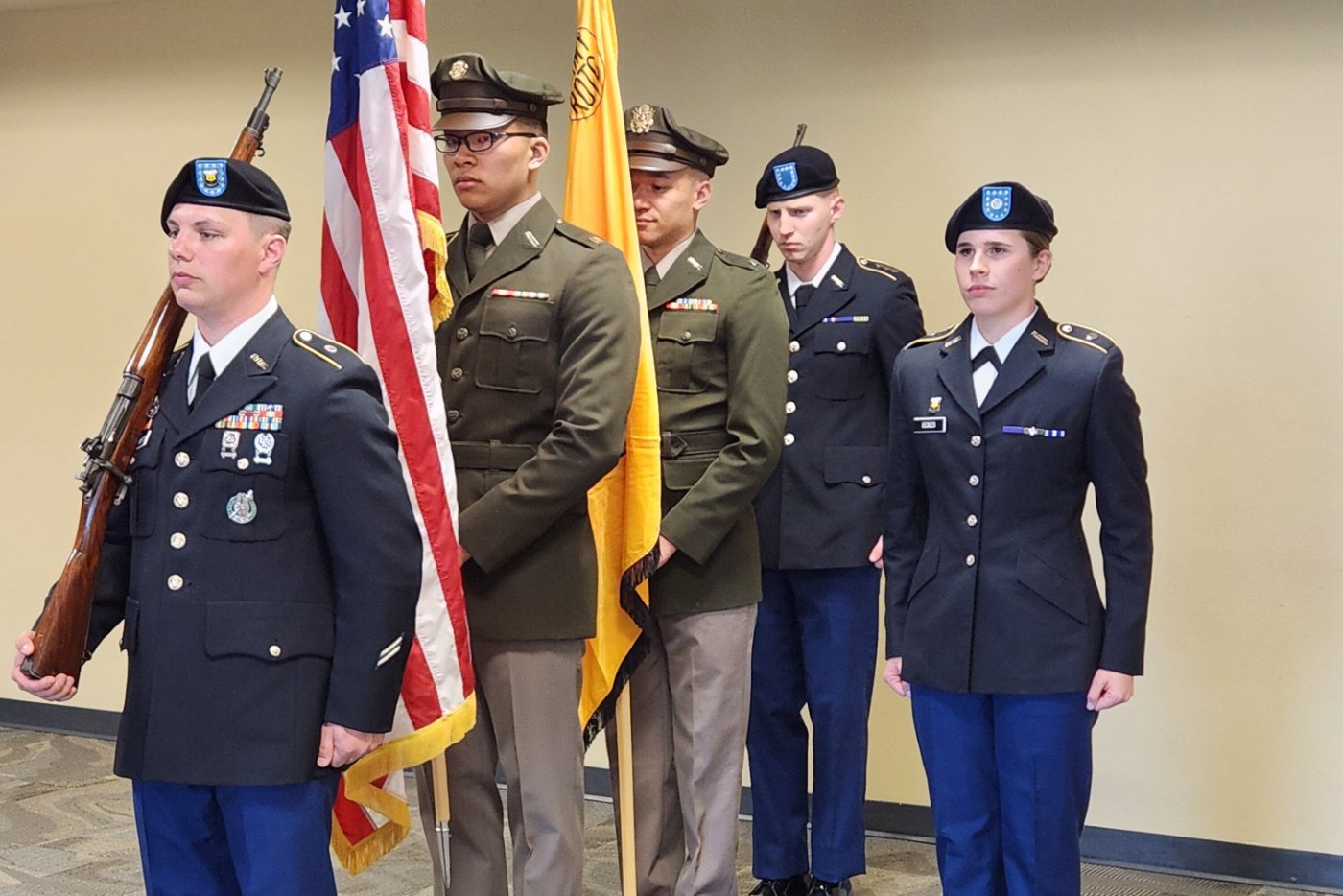 ROTC students in uniform holding American and ROTC flag